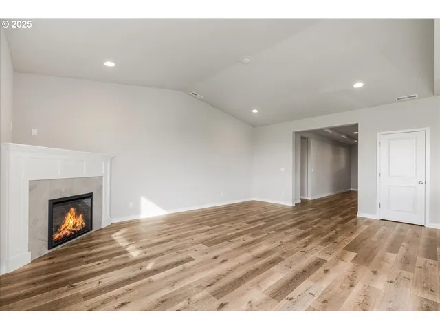 a kitchen with stainless steel appliances granite countertop a sink a stove and a wooden floors