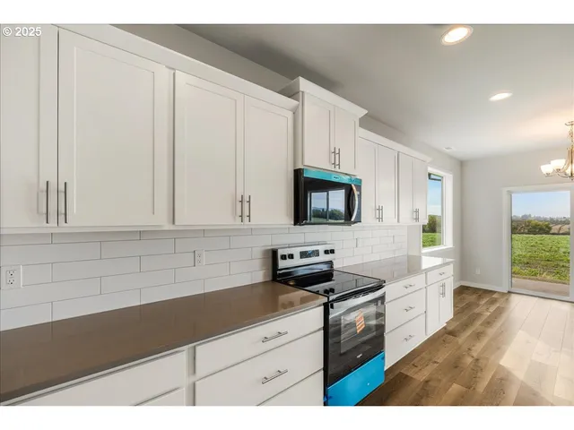 a kitchen with kitchen island sink and stove