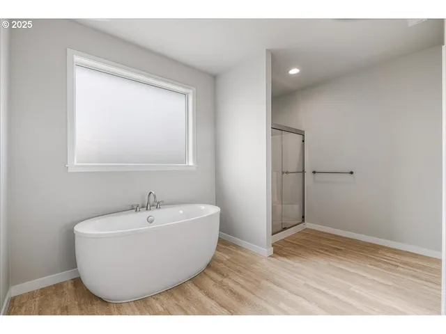 a bathroom with a granite countertop sink mirror and bathtub
