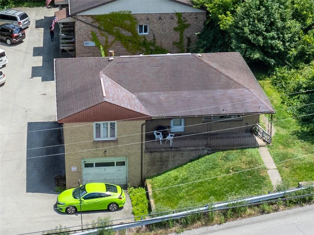 an aerial view of a house with a garden and plants