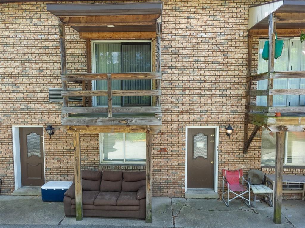 80 Colony Drive Irwin, PA 15642 - Photo 4 of 11 a view of front door of house with outdoor seating