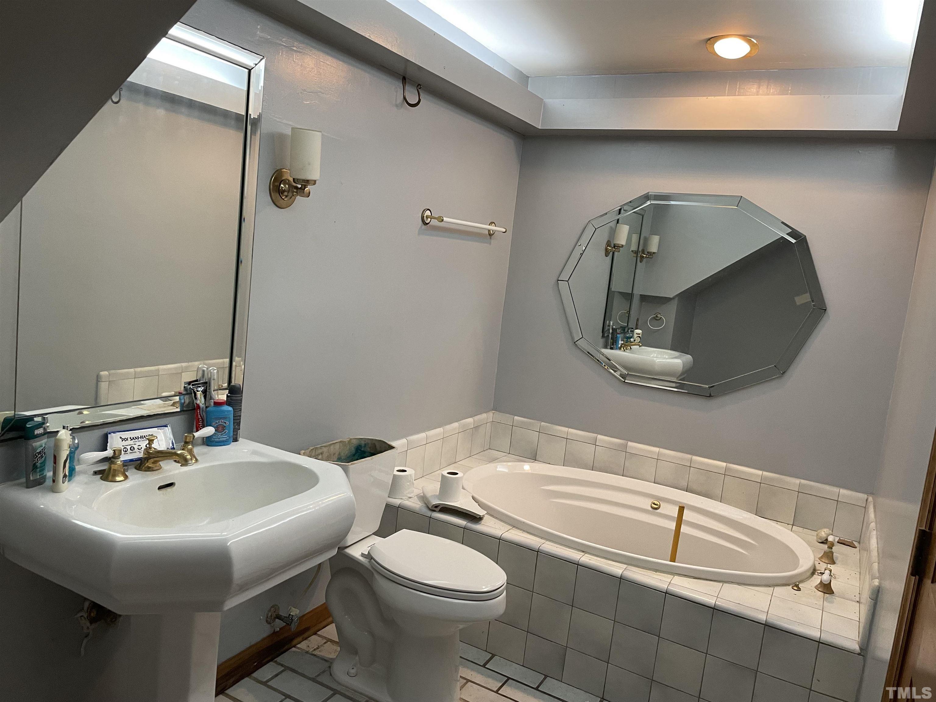 6605 Old Stage Road Raleigh, NC 27603 - Photo 12 of 13 a bathroom with a sink and a mirror