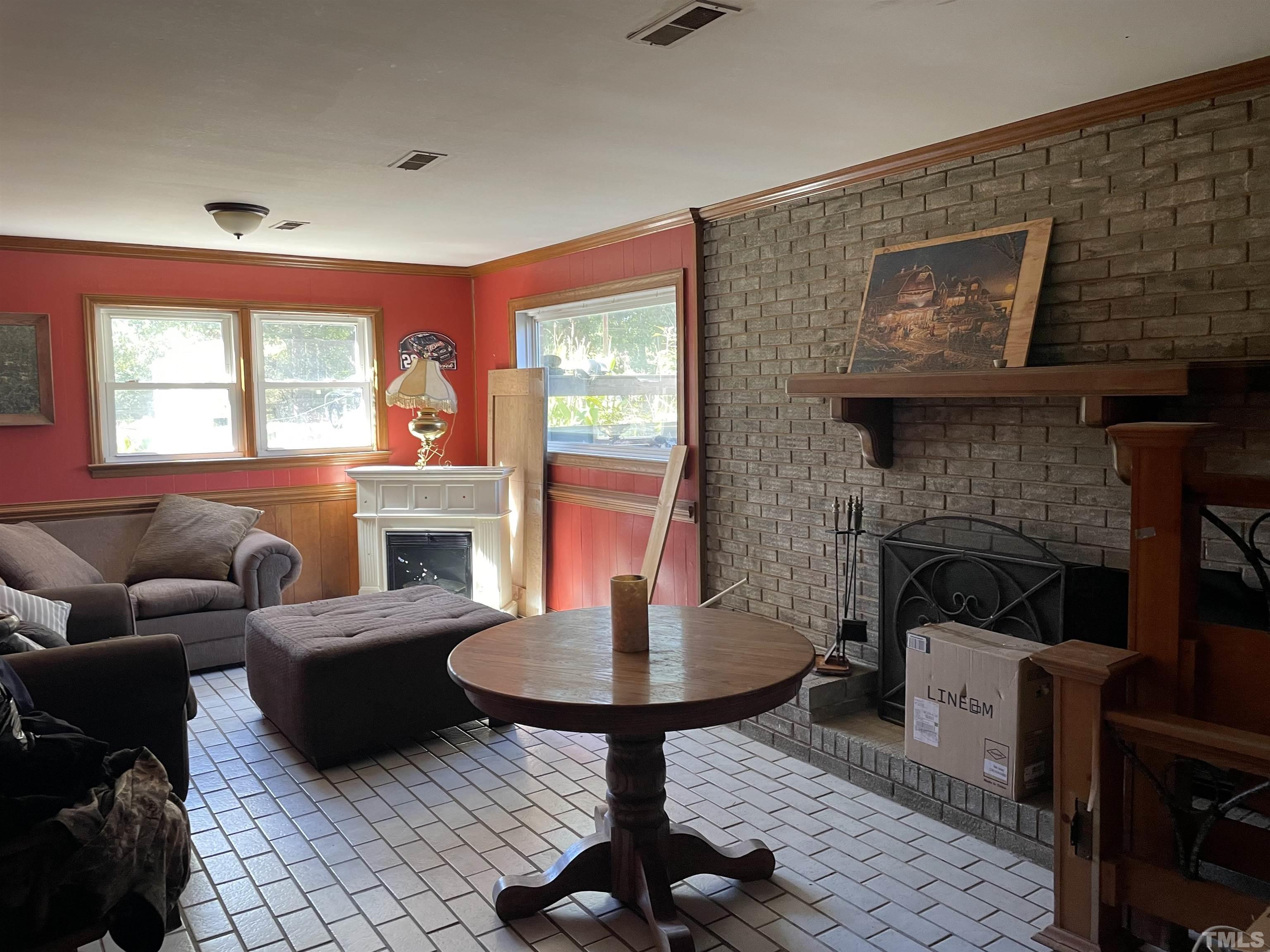 6605 Old Stage Road Raleigh, NC 27603 - Photo 10 of 13 a living room with furniture a window and a fireplace