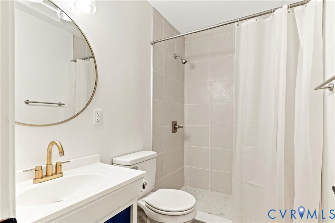 517 West Riverside Drive Lanexa, VA 23089 - Photo 23 of 27 a bathroom with a sink vanity mirror and toilet
