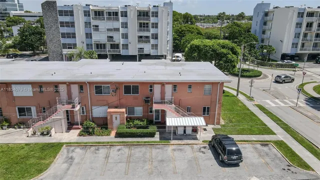 an aerial view of a house with a yard patio and fire pit