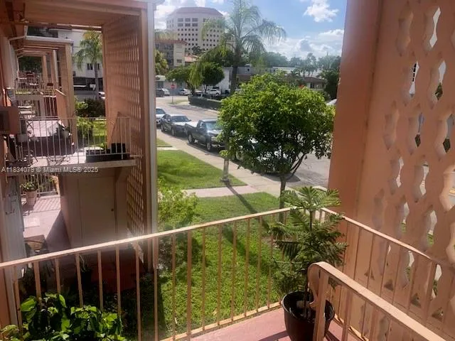 an aerial view of a house with car parked