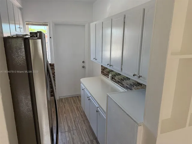 a kitchen with a refrigerator and a sink