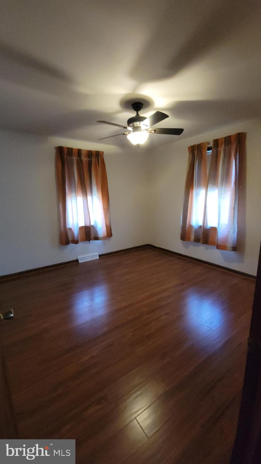 569 Lakeside Avenue Woodbury, NJ 08096 - Photo 7 of 9 a view of an empty room with window and wooden floor