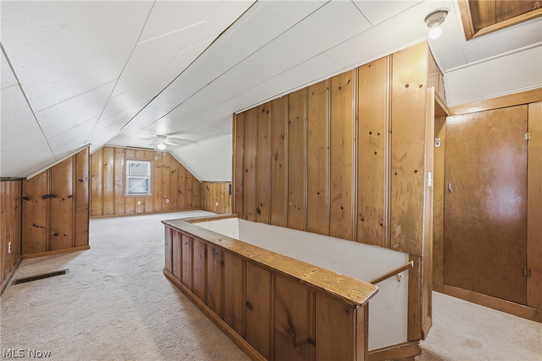 311 Fowles Road Berea, OH 44017 - Photo 21 of 40 Carpeted loft space featuring light wood paneling, a sloped white paneled ceiling, and an integrated window
