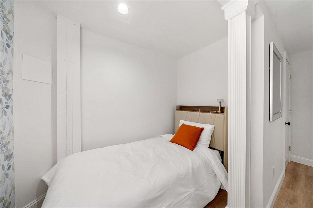 102 Revere Street, Unit 1 Boston, MA 02114 - Photo 22 of 30 a bedroom with a bed and a lamp