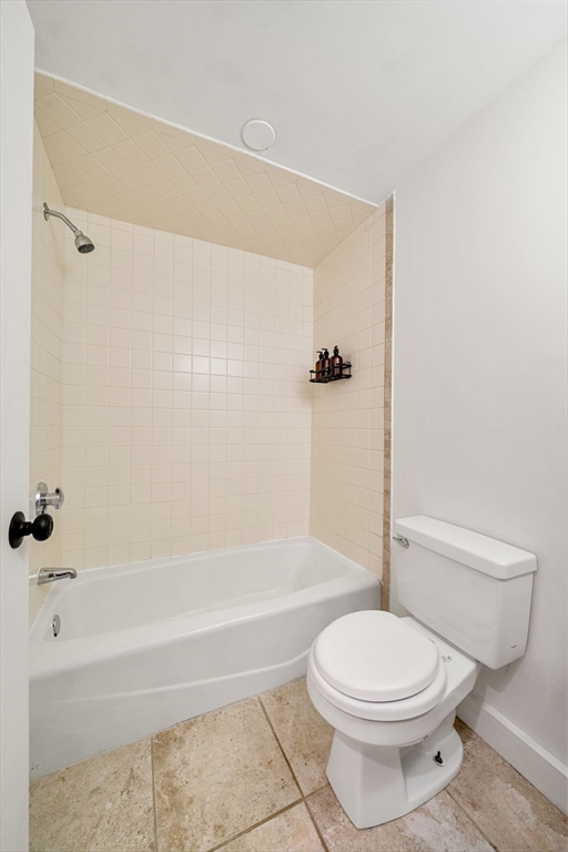 102 Revere Street, Unit 1 Boston, MA 02114 - Photo 25 of 30 a bathroom with a toilet and a bath tub