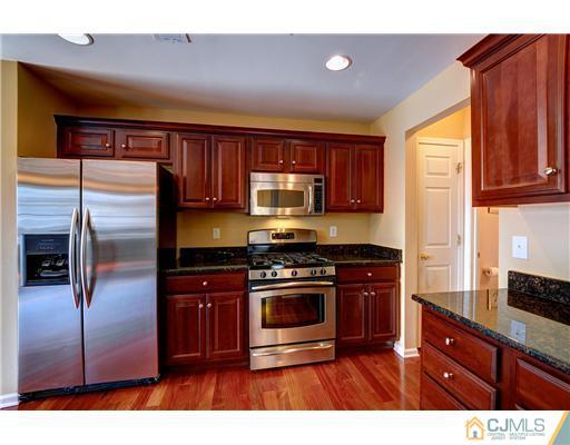 54 Raritan Reach Road South Amboy, NJ 08879 - Photo 12 of 23 a kitchen with stainless steel appliances granite countertop a stove a refrigerator and a microwave