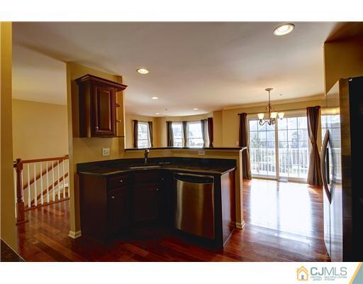 54 Raritan Reach Road South Amboy, NJ 08879 - Photo 13 of 23 a kitchen with a sink refrigerator and cabinets