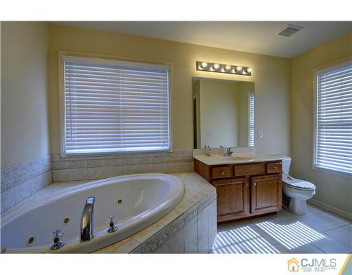 54 Raritan Reach Road South Amboy, NJ 08879 - Photo 18 of 23 a bathroom with a sink a bathtub and a window
