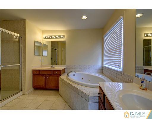 54 Raritan Reach Road South Amboy, NJ 08879 - Photo 19 of 23 a bathroom with a tub sink and mirror