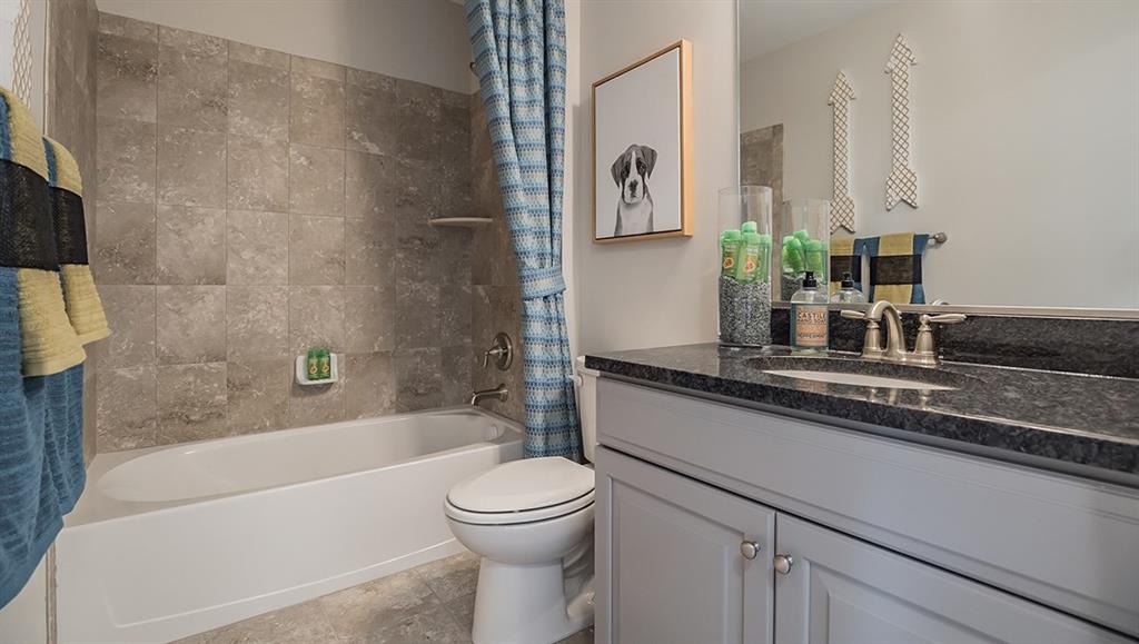 1402 Hights Farm Road South Raleigh, NC 27603 - Photo 11 of 25 a bathroom with a granite countertop bathtub sink vanity mirror and toilet