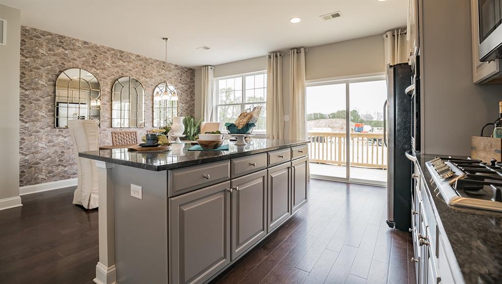 1402 Hights Farm Road South Raleigh, NC 27603 - Photo 14 of 25 a kitchen with stainless steel appliances granite countertop a stove a sink dishwasher a refrigerator and white cabinets with wooden floor