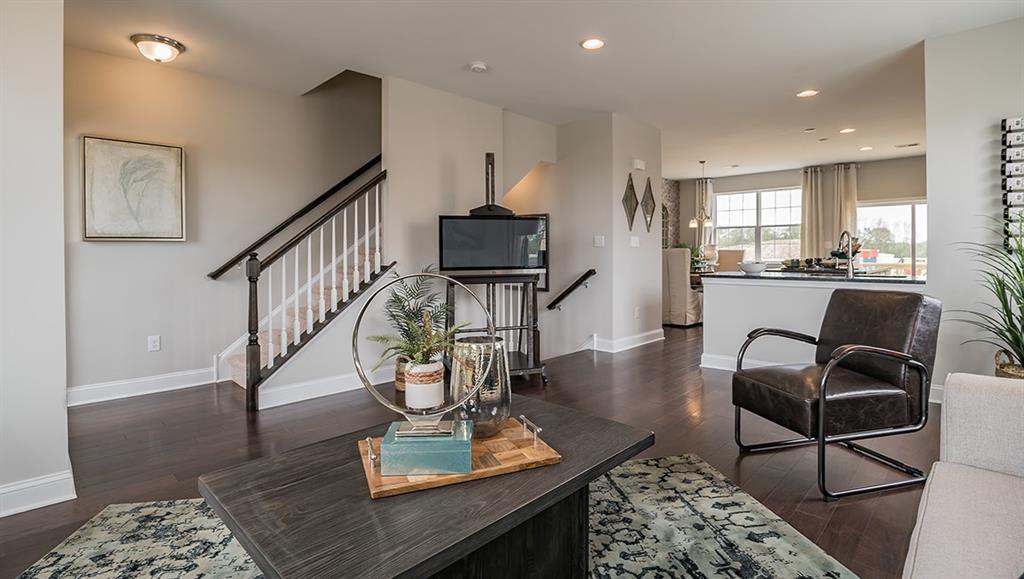 1402 Hights Farm Road South Raleigh, NC 27603 - Photo 18 of 25 a living room with furniture and a wooden floor