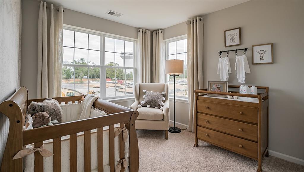 1402 Hights Farm Road South Raleigh, NC 27603 - Photo 20 of 25 a bedroom with furniture and a large window