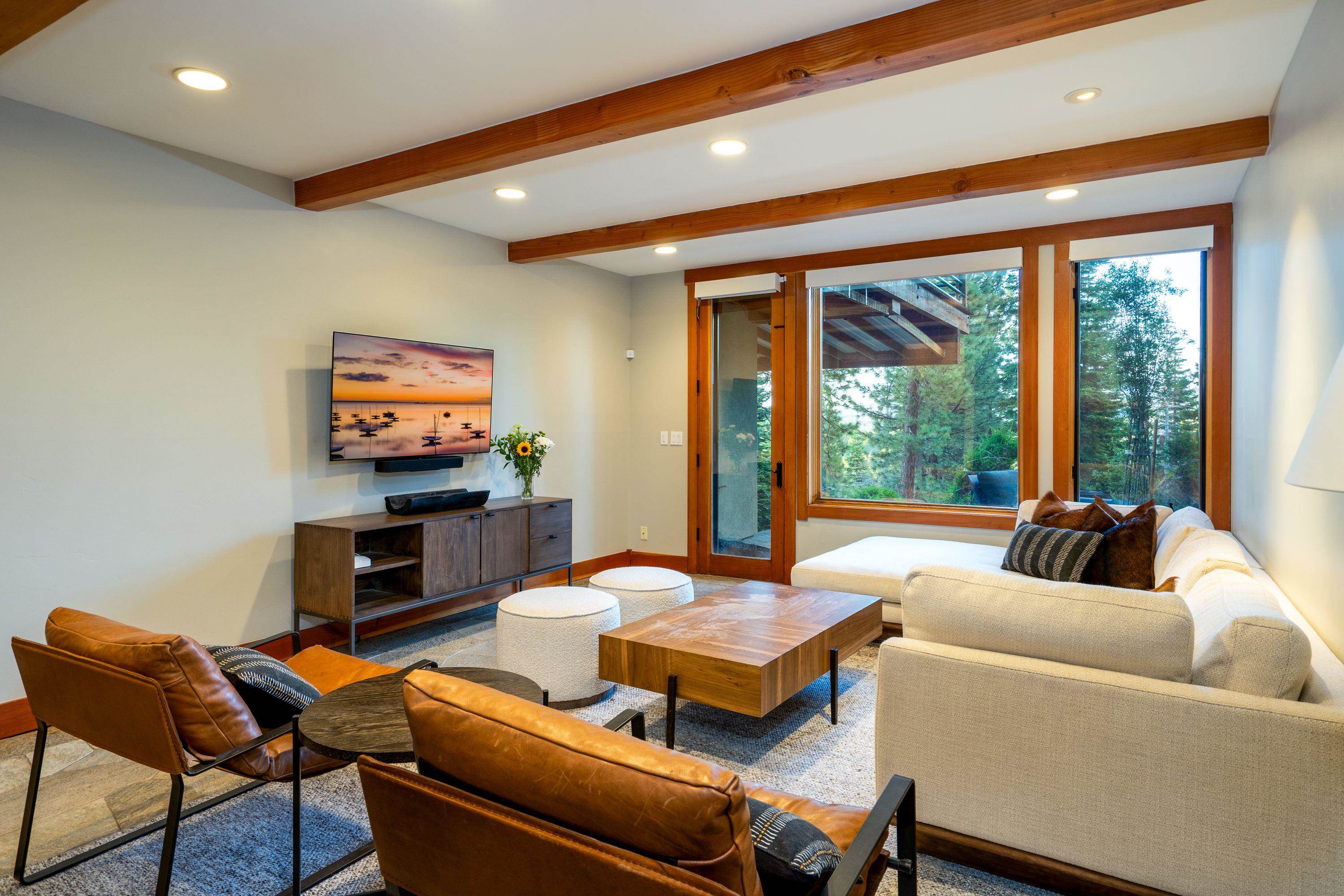 1723 Grouse Ridge Road Truckee, CA 96161 - Photo 10 of 27 a living room with furniture a floor to ceiling window and a flat screen tv