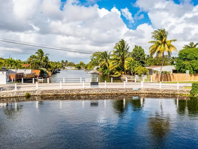 a view of swimming pool with outdoor seating and plants