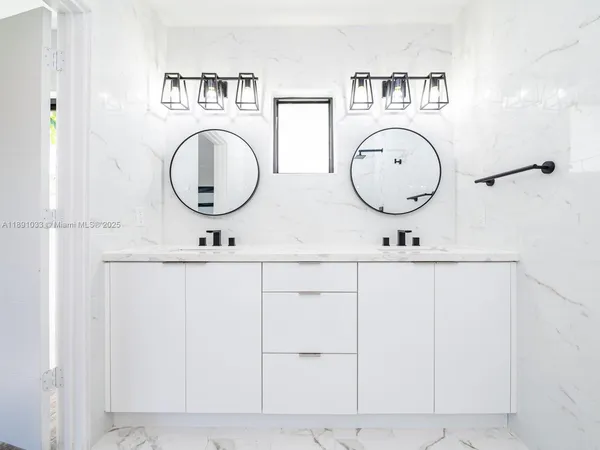 a bathroom with a sink a toilet and a shower