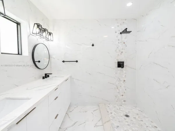 a bathroom with a sink a toilet and mirror