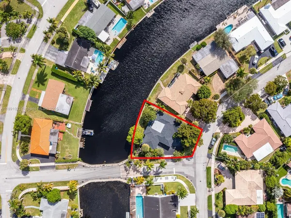 an aerial view of a house with a yard and pool