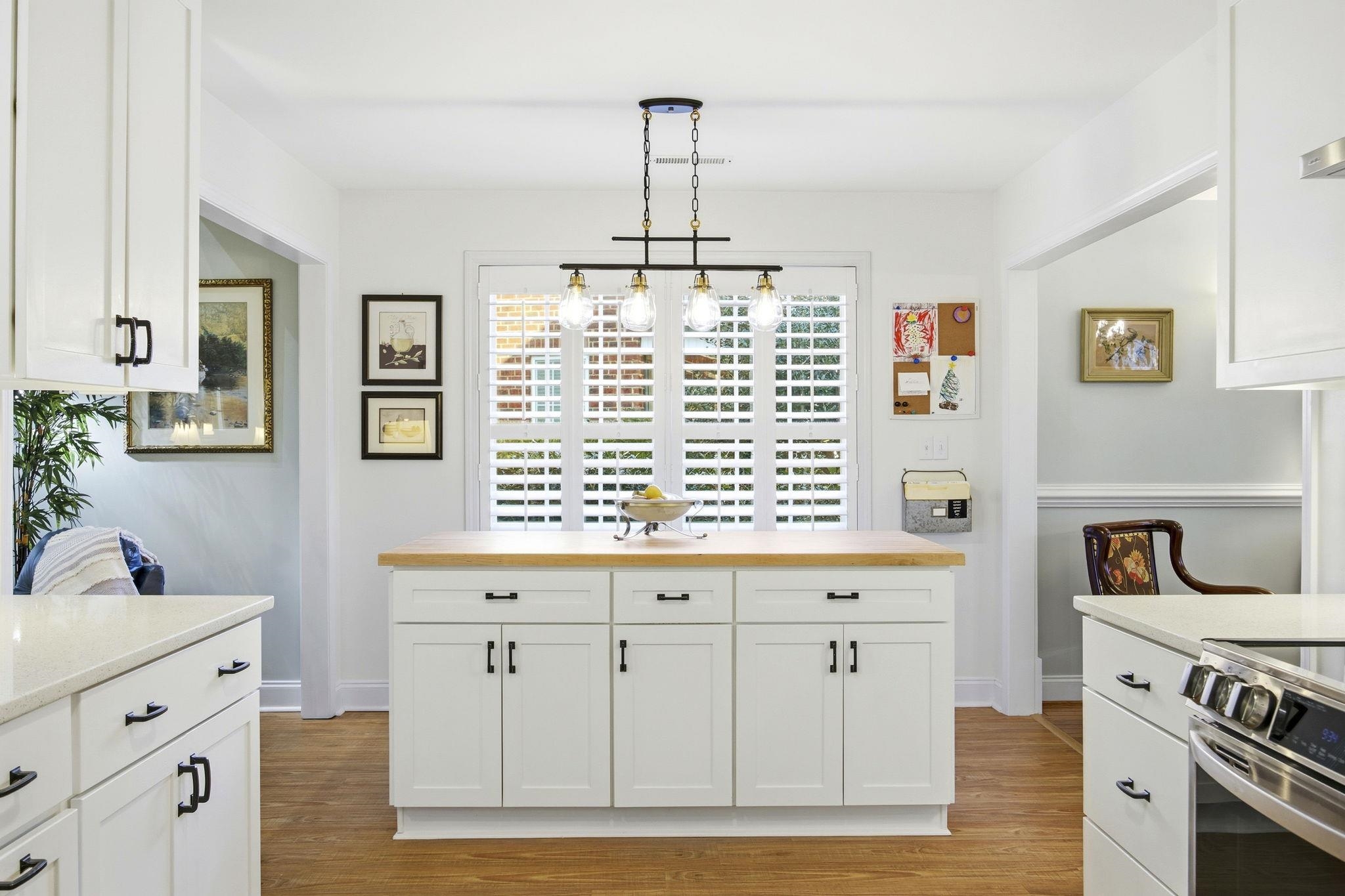 1301 Regent Terrace North Surfside Beach, SC 29575 - Photo 15 of 40 Kitchen featuring white cabinetry, stainless steel range with electric cooktop, hanging light fixtures, butcher block counters, and light wood-style floors