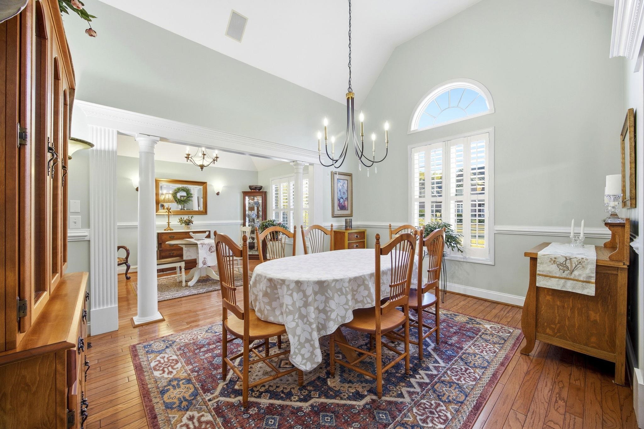 1301 Regent Terrace North Surfside Beach, SC 29575 - Photo 20 of 40 Dining room featuring light wood finished floors, high vaulted ceiling, ornate columns, and a chandelier