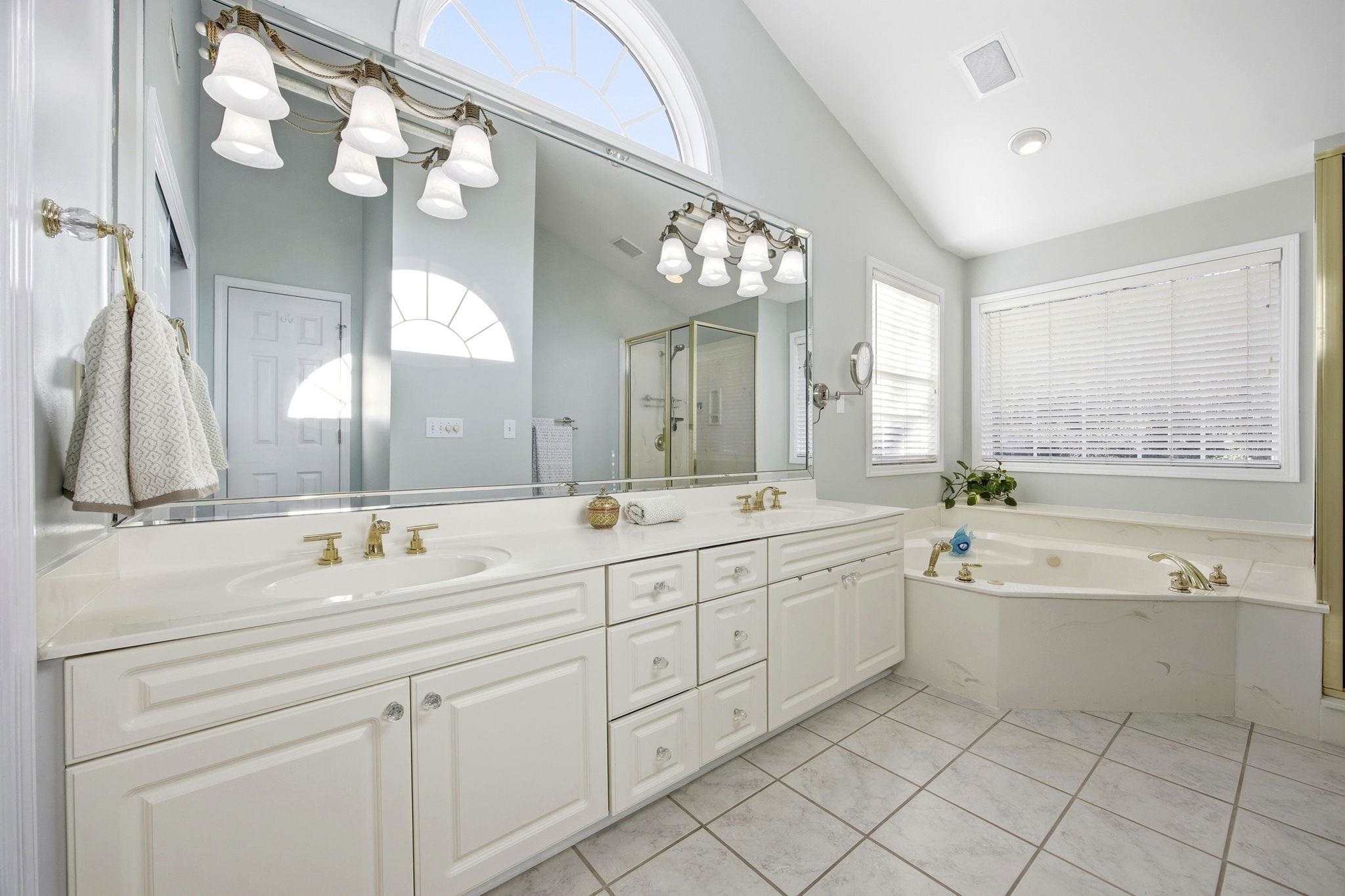 1301 Regent Terrace North Surfside Beach, SC 29575 - Photo 23 of 40 Bathroom featuring double vanity, lofted ceiling, a shower stall, a bath, and light tile patterned floors