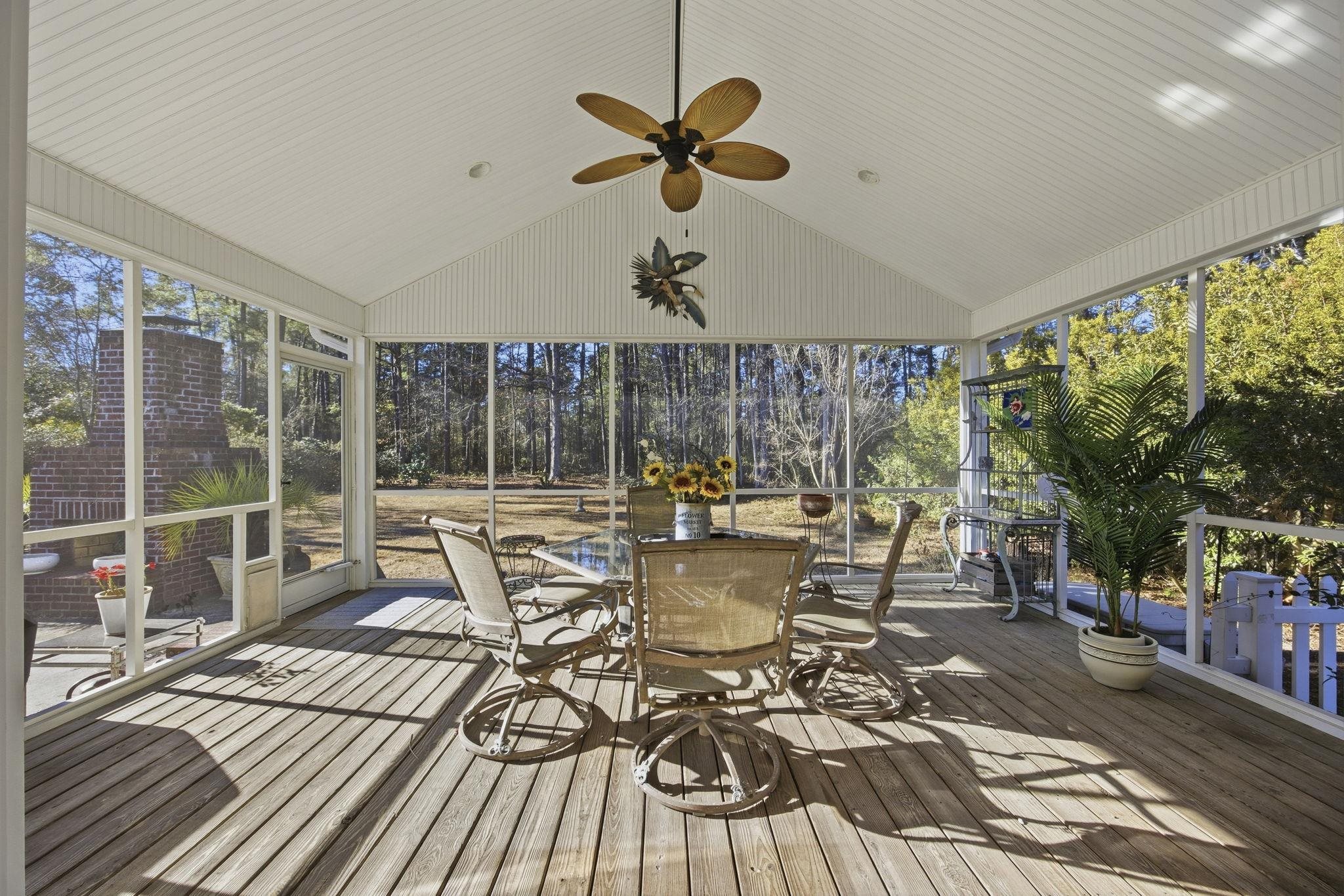 1301 Regent Terrace North Surfside Beach, SC 29575 - Photo 33 of 40 Unfurnished sunroom with a ceiling fan, outdoor dining space, lofted ceiling, and a wooden deck