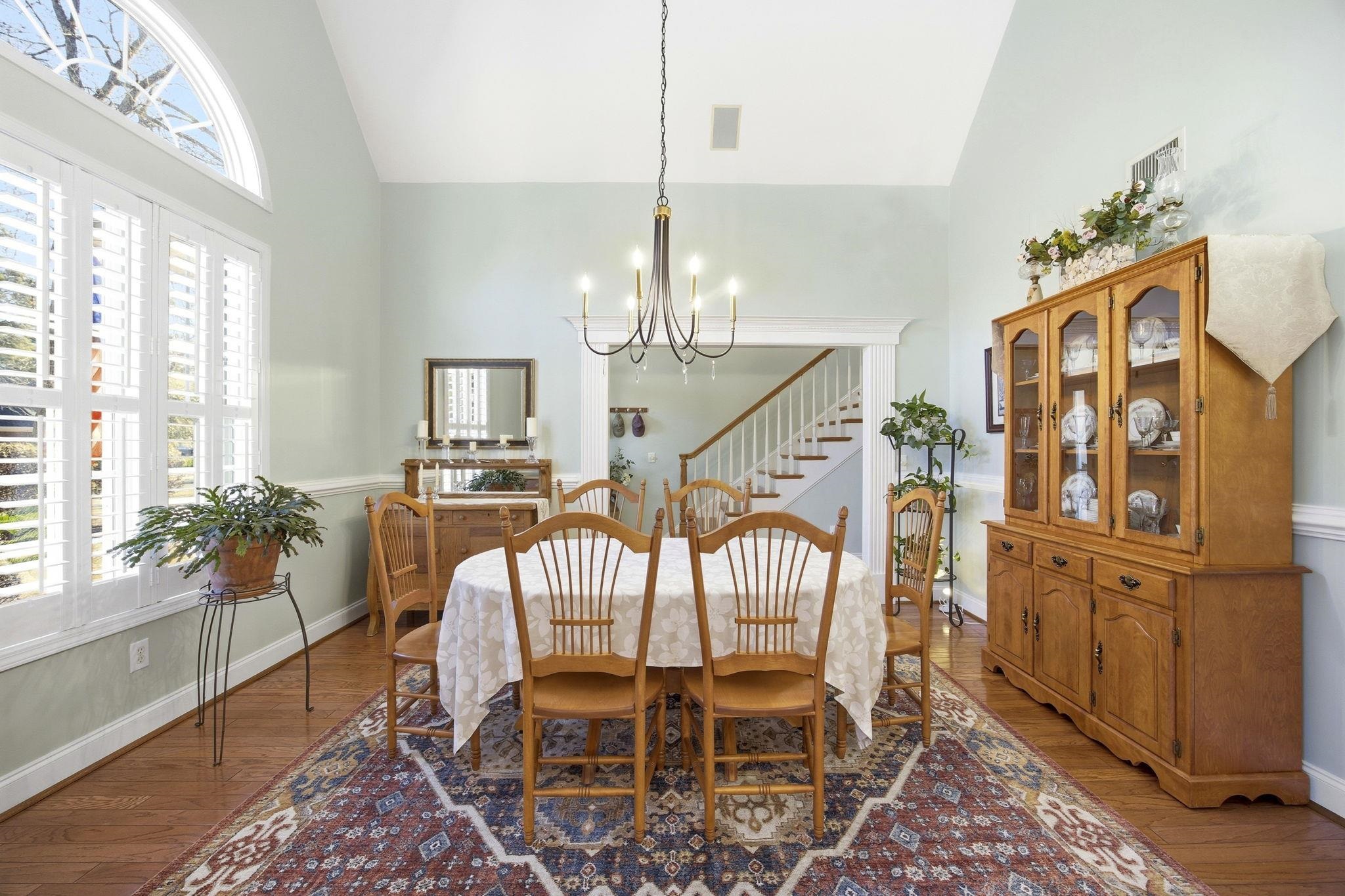 1301 Regent Terrace North Surfside Beach, SC 29575 - Photo 4 of 40 Dining room with hardwood / wood-style floors, stairs, high vaulted ceiling, and a chandelier