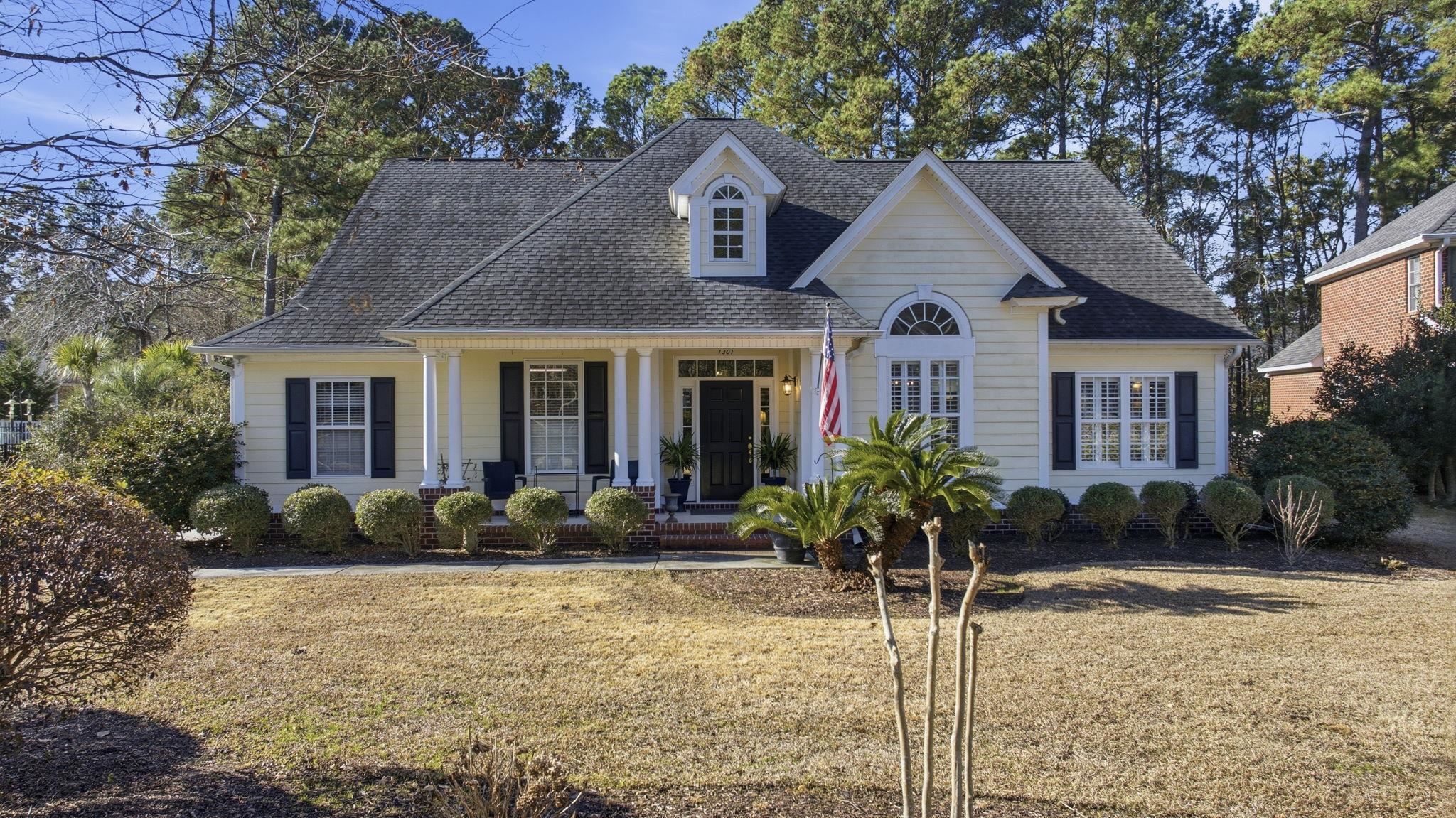 1301 Regent Terrace North Surfside Beach, SC 29575 - Photo 6 of 40 View of front of home featuring a front yard, a porch, and a shingled roof