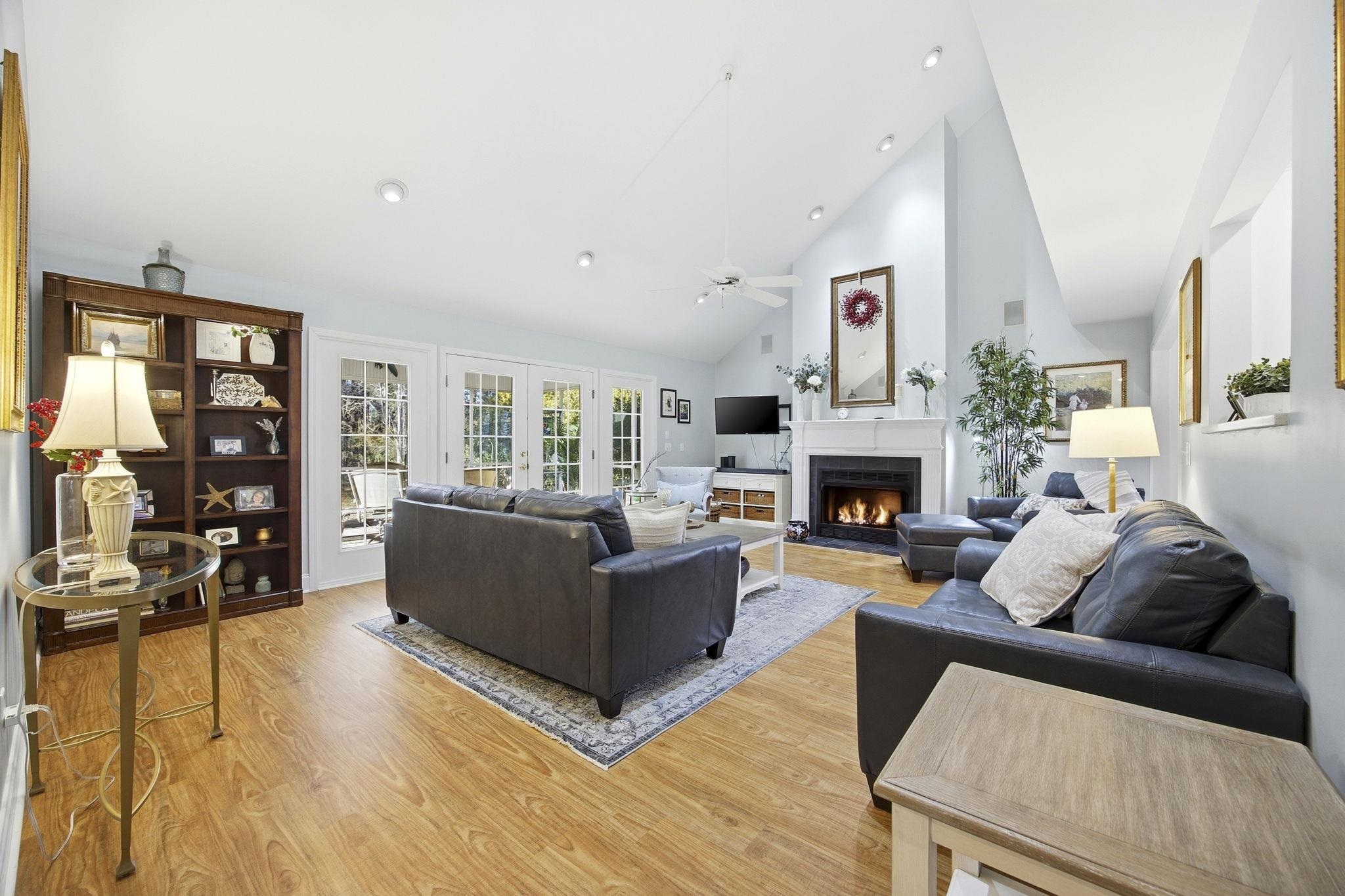 1301 Regent Terrace North Surfside Beach, SC 29575 - Photo 9 of 40 Living room with a warm lit fireplace, high vaulted ceiling, light wood-type flooring, and ceiling fan