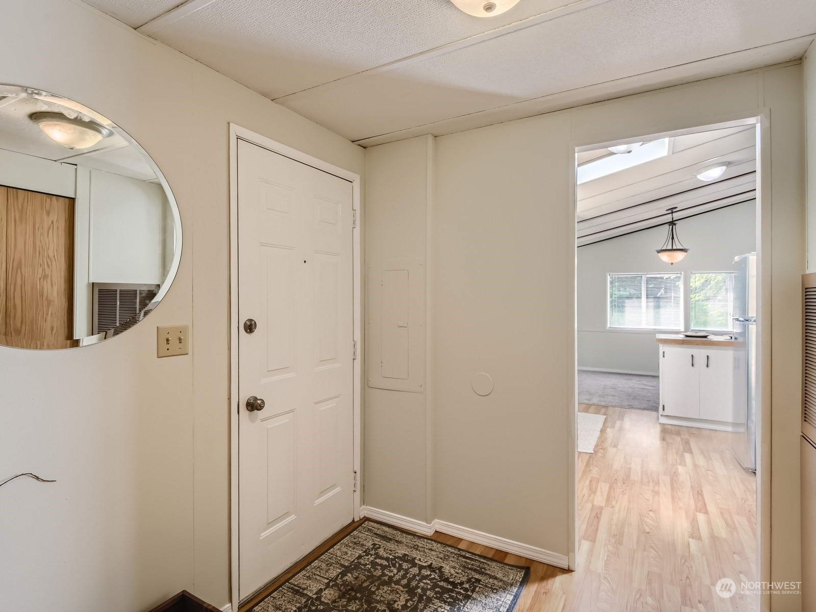 20614 West Richmond Road Bothell, WA 98021 - Photo 4 of 24 a view of a hallway with wooden floor and a bathroom