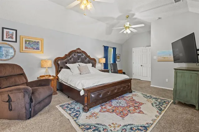 a bedroom with a bed and a television