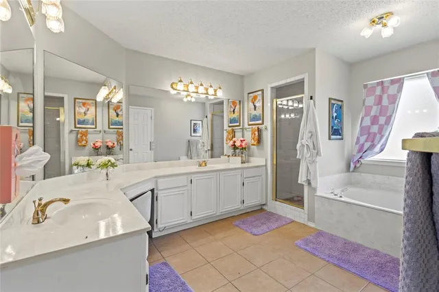 a spacious bathroom with a sink mirror and a bath tub