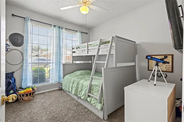 a bedroom with bed and a chandelier