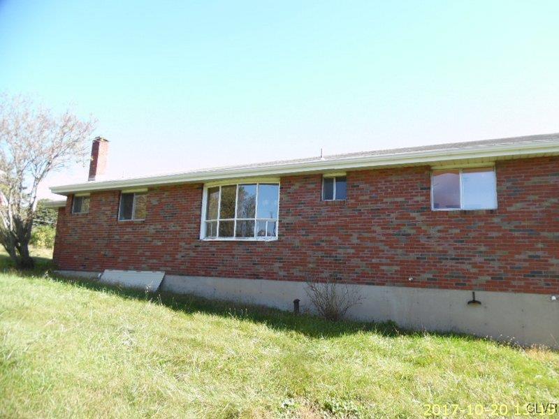 731 Point Phillips Road Bath, PA 18014 - Photo 4 of 22 a brick house with a yard