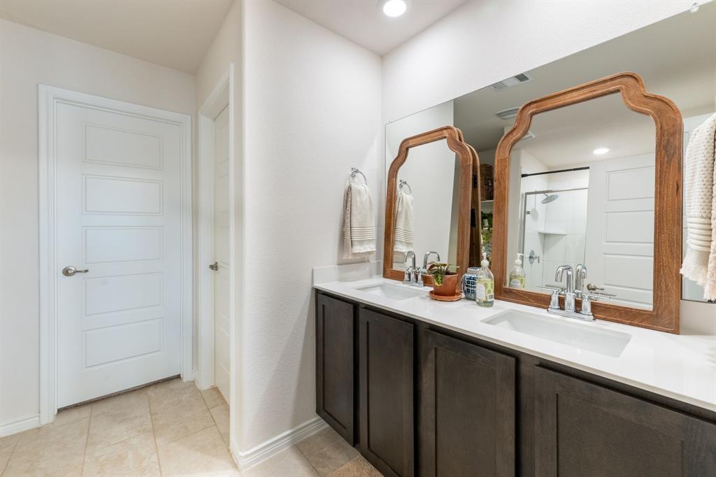 224 Wakefield Road Fate, TX 75189 - Photo 16 of 30 a bathroom with a double vanity sink mirror and a