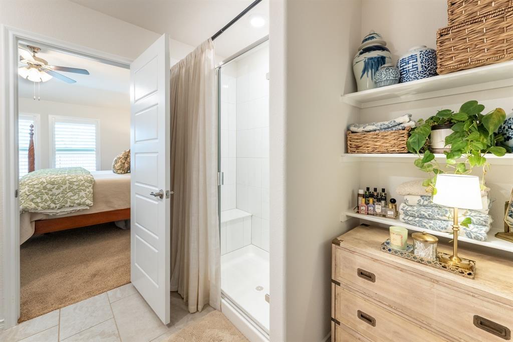 224 Wakefield Road Fate, TX 75189 - Photo 17 of 30 a en suite bathroom with a sink a mirror and a shower