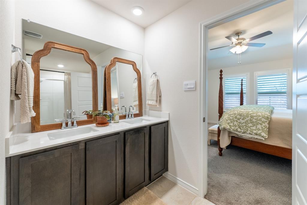 224 Wakefield Road Fate, TX 75189 - Photo 18 of 30 a en suite bathroom with a double vanity sink and a mirror