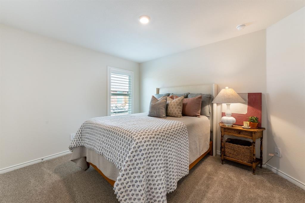 224 Wakefield Road Fate, TX 75189 - Photo 19 of 30 a bedroom with a bed and a window