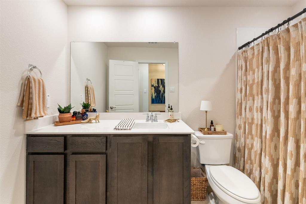 224 Wakefield Road Fate, TX 75189 - Photo 21 of 30 a bathroom with a double vanity sink toilet and a mirror