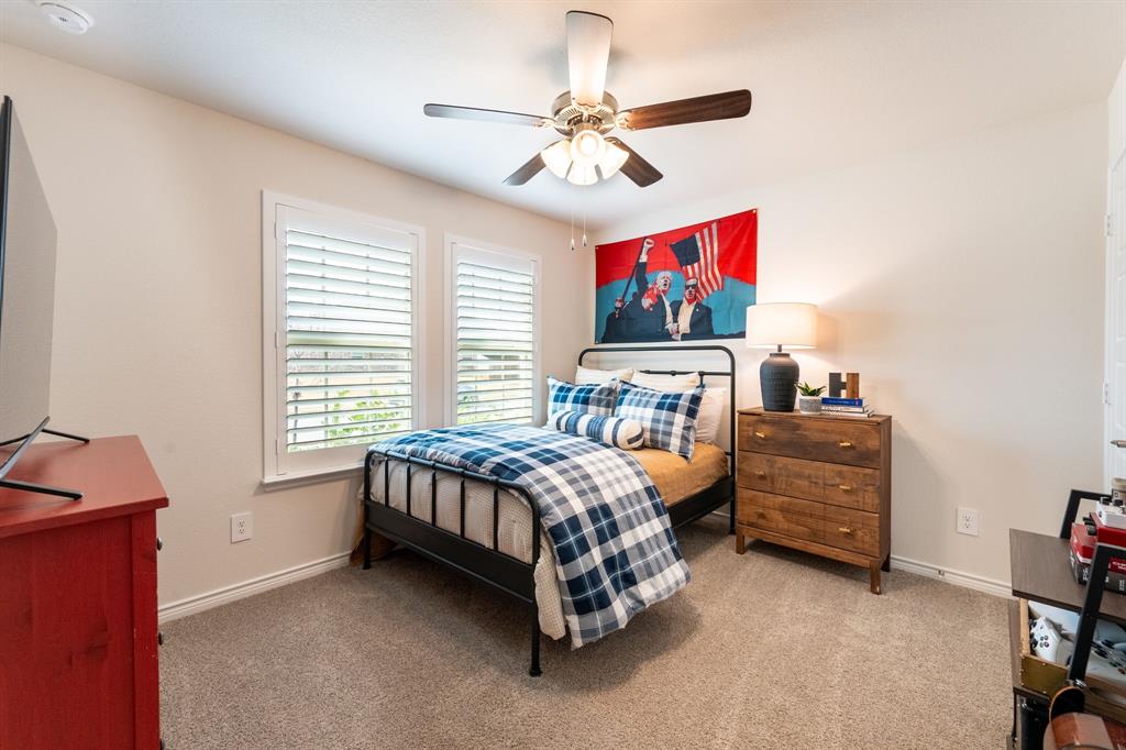 224 Wakefield Road Fate, TX 75189 - Photo 22 of 30 a bed room with a bed and a television