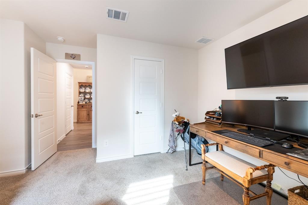 224 Wakefield Road Fate, TX 75189 - Photo 24 of 30 a view of a livingroom with furniture and a flat screen tv