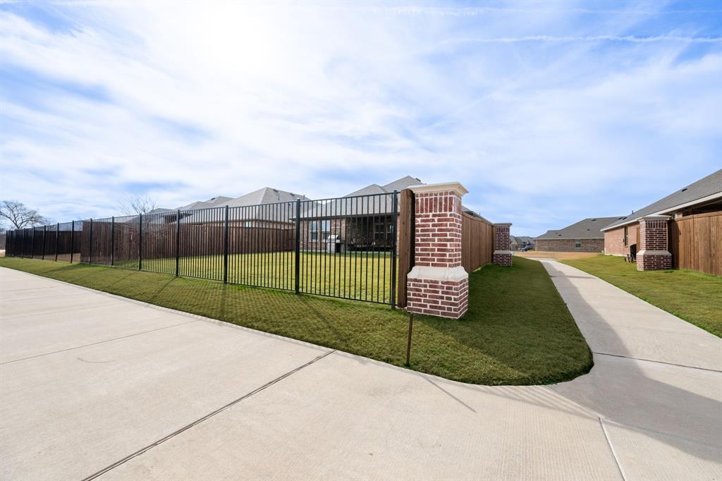 224 Wakefield Road Fate, TX 75189 - Photo 28 of 30 a view of a street with brick building in front of it