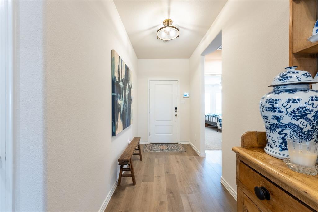 224 Wakefield Road Fate, TX 75189 - Photo 4 of 30 a view of a room with wooden floor and lots of frames on wall