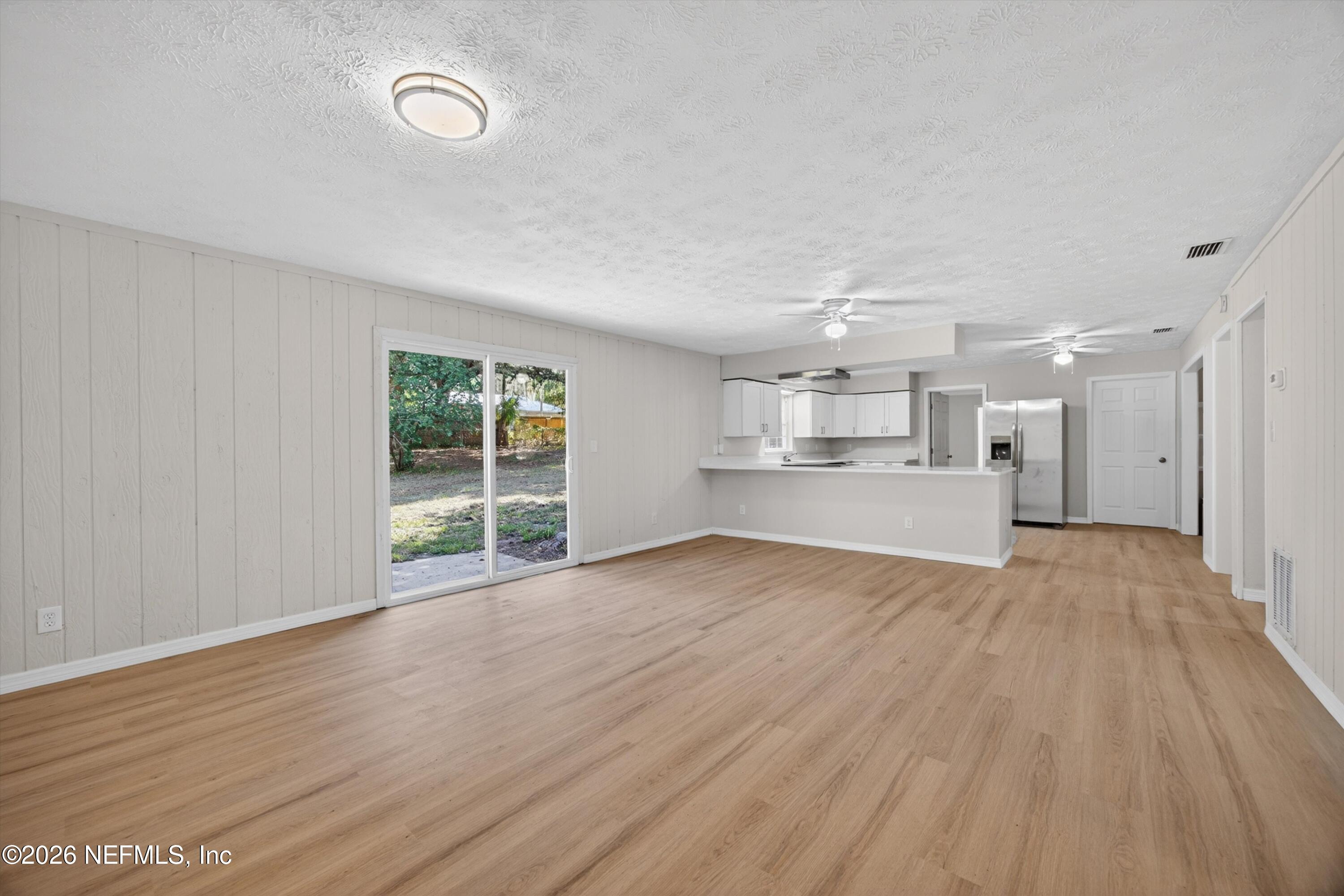 6894 Ridge Street Keystone Heights, FL 32656 - Photo 11 of 40 a view of a kitchen with wooden floor and a window